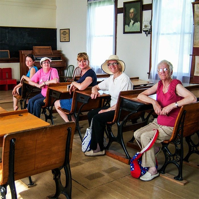 Tour group from the UK in Schoolhouse at Independence, Kansas site. 