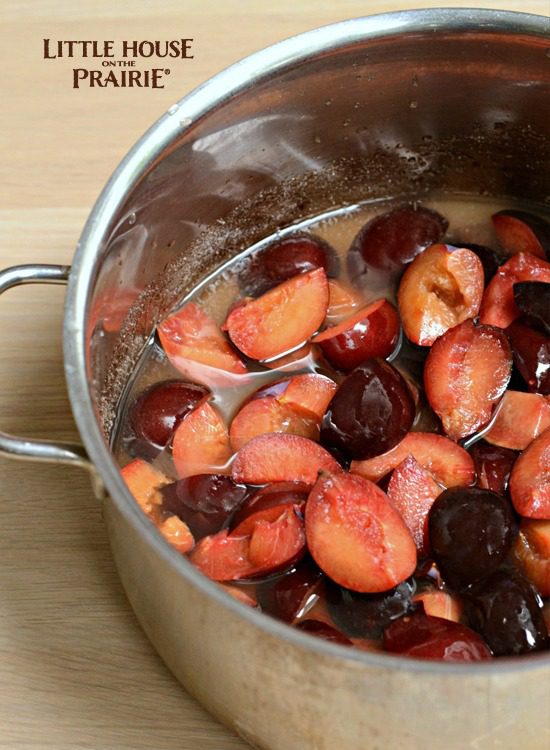 Plums are pitted and halved and ready to boil into preserves. 
