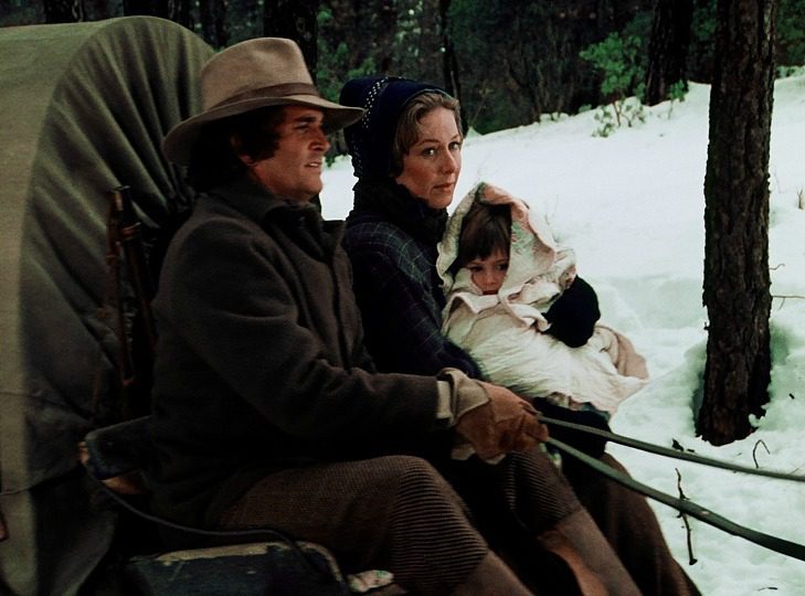 Baby Carrie wrapped in a quilt in the Little House on the Prairie Pilot.