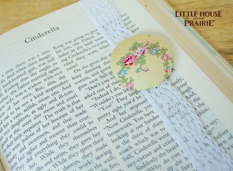 Fabric-covered button bookmark with old-fashioned lace. 