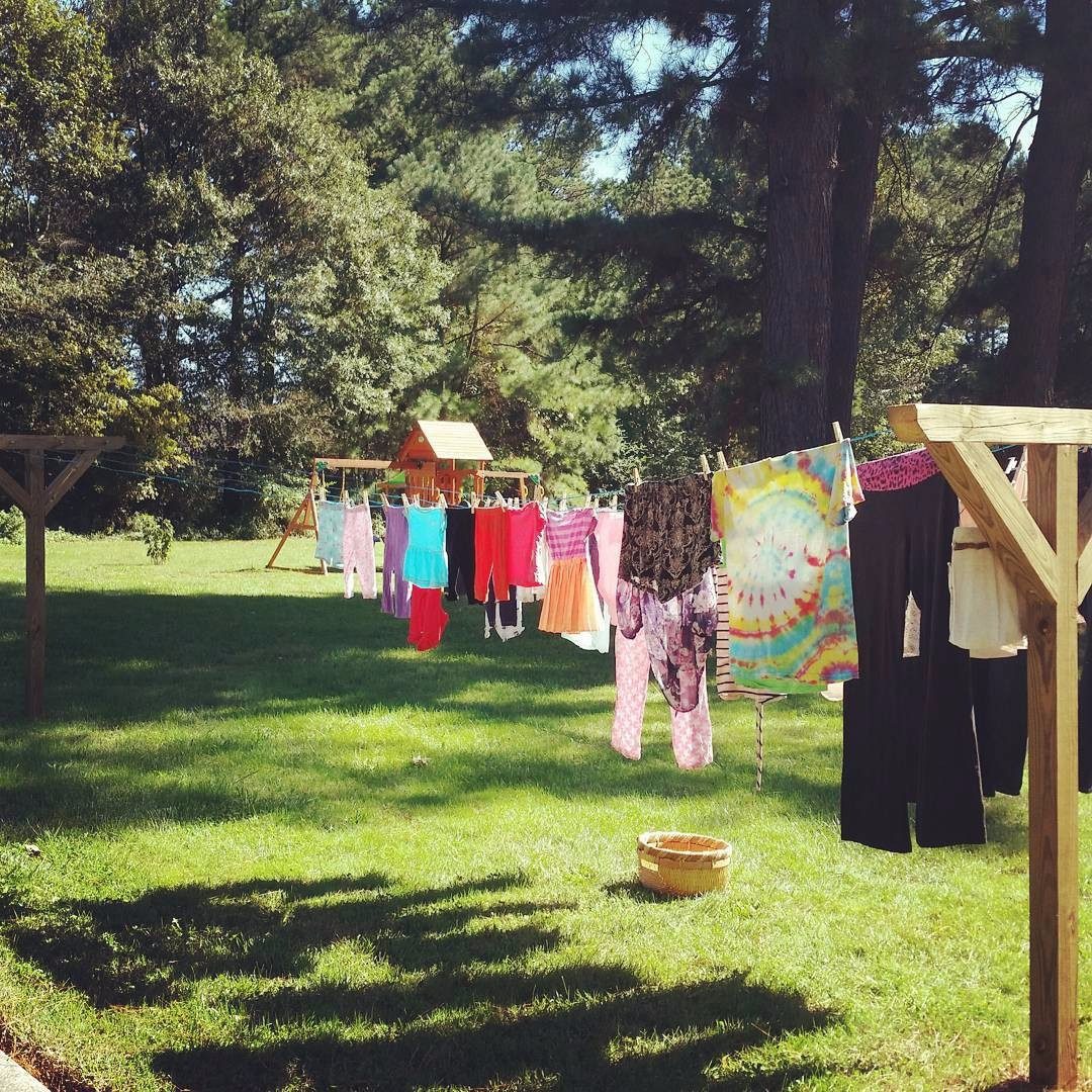 Frugal living makes a bright and cheerful #LittleHouseMoment with these colorful clothes on the line.