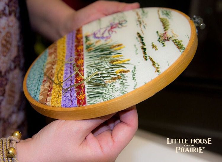 Add the embellishments with embroidery stitches over the fabric's printed design - gorgeous Little House on the Prairie hoop project.