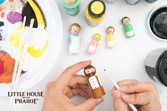 Painting the details on your Little House on the Prairie wooden peg dolls. 